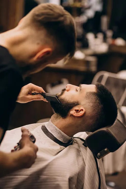 A beard being lined up in the barber chair
